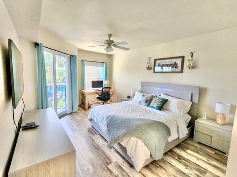 Master bedroom with designated workspace and access to porch.