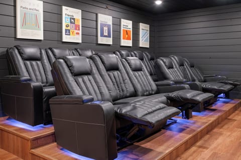 Private theater room with reclining cinema-style seating and a large screen for movie nights in.