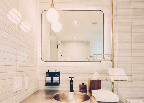 Refresh at the sleek vanity with spa-like lighting and linens.