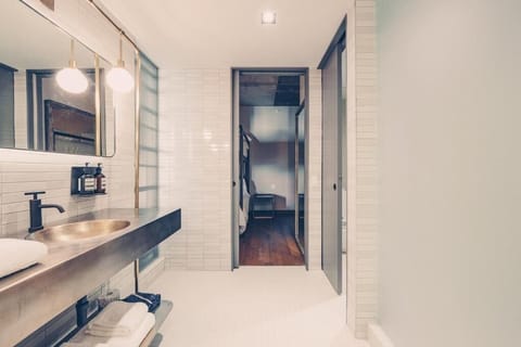 Indulge in a bright, tiled bath with generous counter space.