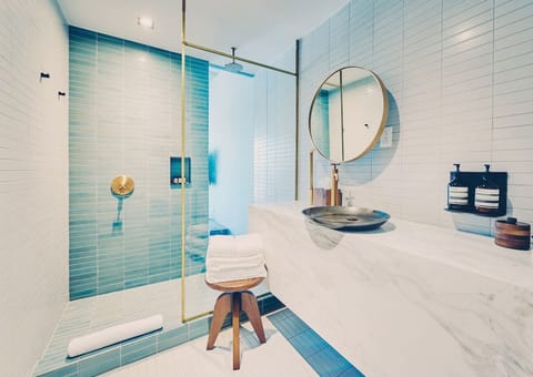 Refresh under the rainfall shower with spa-like tile glow.