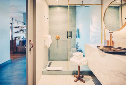 Step into a bright, glass shower for an easy reset.