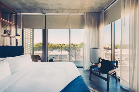 Wake up to skyline views from a sunlit, dreamy bed.