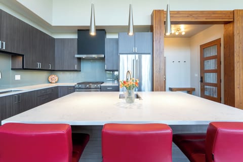 Full kitchen with bar seating for three people | Main Level