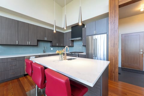 Full kitchen with bar seating for three people | Main Level