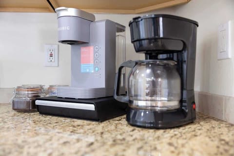 Cook with ease in this fully stocked kitchen featuring modern appliances, granite countertops, and all the essentials—perfect for everything from morning coffee to family dinners.

