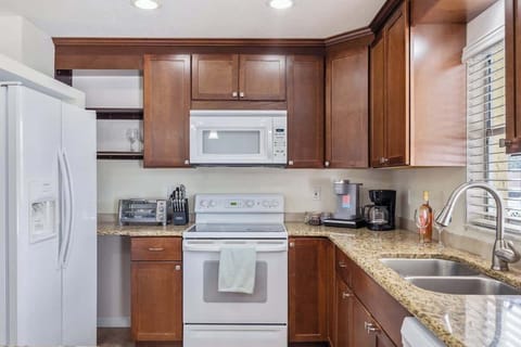Cook with ease in this fully stocked kitchen featuring modern appliances, granite countertops, and all the essentials—perfect for everything from morning coffee to family dinners.
