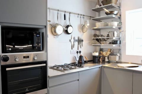 Electric oven, gas hob, Bodum kettle, Le Creuset cookware