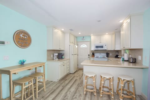 Breezy and bright—this open-concept kitchen brings coastal charm to every meal.