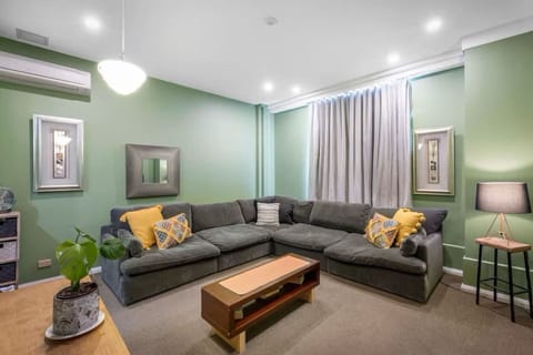 Unwind in the cosy living area with an oversized L-shaped sofa and a TV—perfect for relaxing after exploring Hobart’s cultural gems.