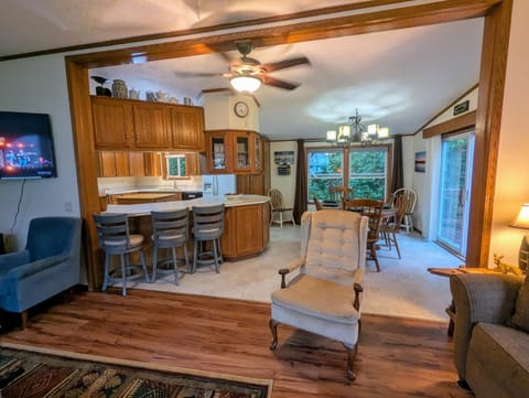 Open concept living to dining room and kitchen.