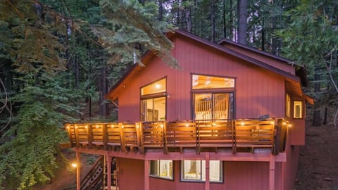 view of the cabin exterior and deck at dusk
