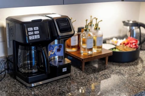 Tabletop with coffee maker, flavored syrups and coffee pods