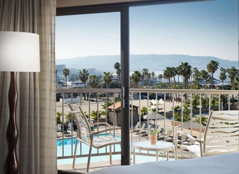 Sip morning coffee on the balcony overlooking palms and pool.