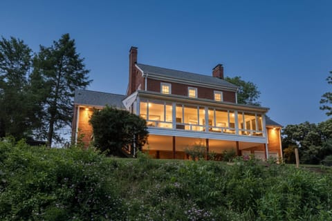 View of the back exterior and steps leading down to the lake