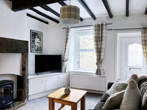 Beamed lounge with log burner and TV