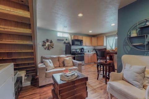 Full kitchen, living room space and two queen beds