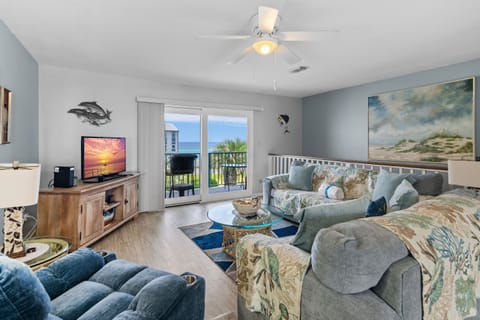 Bright and airy coastal living room with stunning water views right from your couch. Kick back, relax, and let the gulf do the rest