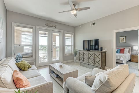 Living area with ample seating, Smart TV, and balcony 