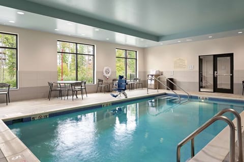 Dive into a bright indoor pool with peaceful views.