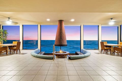 Oceanfront condo perks: cozy lounge, firepit, and sunset views 🌅🔥