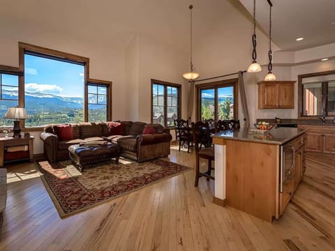 - Dine with a view at the table beside wide windows or sip wine on the comfy leather sofa
- Kitchen, living, and dining come together in a warm, wood accented setting
- Bright natural light and fresh mountain air fill every corner here