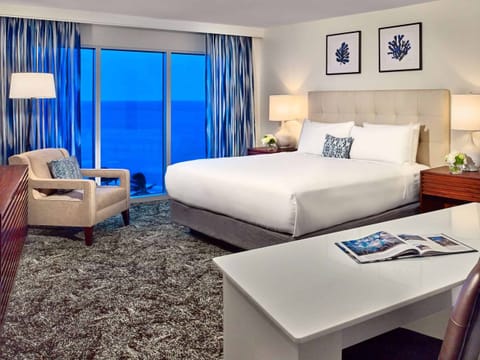 Relax at dusk as deep-blue ocean light fills the room.