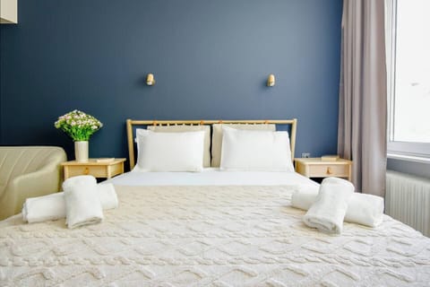 Rest easy in this bright, elegant bedroom with soft linens and a cozy vibe. Need anything extra for your stay? Message us anytime!