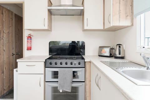 Modern kitchen with a gas stove, ample counter space, and essential appliances—ideal for home-cooked meals.