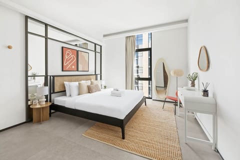 A cozy and modern bedroom featuring a plush bed, soft linens, bedside tables, and ample natural light—designed for restful nights and peaceful mornings.