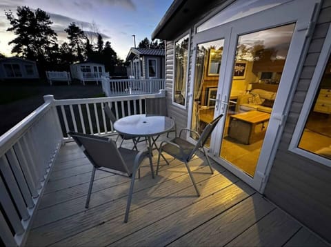 Enjoy peaceful mornings or sunset drinks on your private deck—complete with cozy seating and warm lighting for a perfect outdoor retreat.