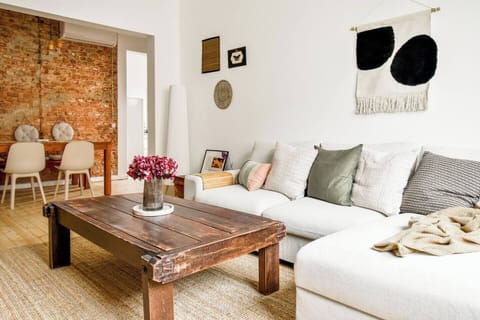 “Unwind in this bright boho living room—earthy textures, curated art, and rustic charm in every detail.”
➡️ Book your stay and feel instantly at home.