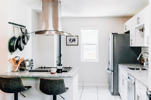 Fully stocked kitchen with a breakfast bar