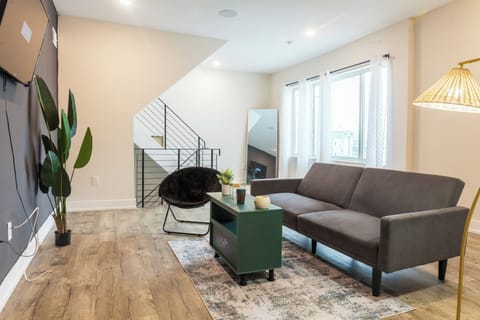Cozy and inviting living room with comfortable seating, a smart TV, and plenty of natural light—perfect for relaxing or socializing.

