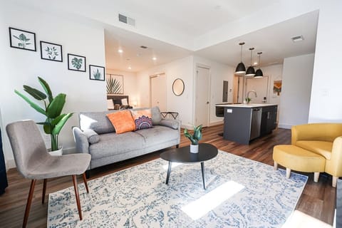 Modern living room with stylish furniture and decor, exemplifying contemporary interior design. The open layout seamlessly connects the living area to other parts of the space, creating an inviting atmosphere. #SocializingHub