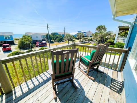 Relax in your private wooden rocking chairs while enjoying ocean breezes and views of the tropical neighborhood below.
