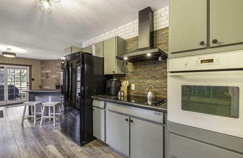Kitchen with full-sized refrigerator, air fryer, stove, and oven