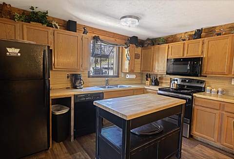 The kitchen has warm wooden cabinetry and everything you need to whip up your next meal.