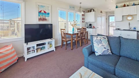 Living room has a large flat screen tV