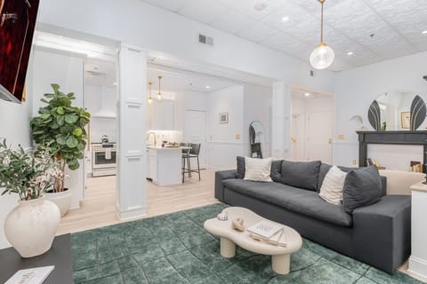 Unit 1: Open-Concept Living Area featuring designer furnishings, and a Smart TV.