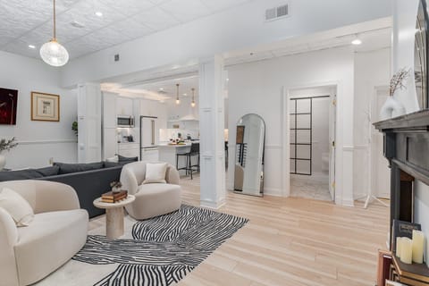 Unit 1: Open-Concept Living Area featuring designer furnishings, and a Smart TV.