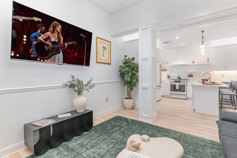 Unit 1: Open-Concept Living Area featuring designer furnishings, and a Smart TV.