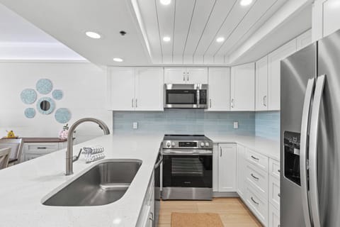 This modern coastal kitchen invites you to cook, gather, and unwind, with sleek finishes, ocean-inspired details, and all the comforts of home.