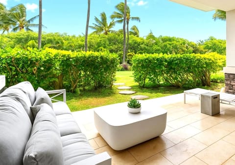 The spacious lanai with various seating options opens up to a stunning garden area MON-2206