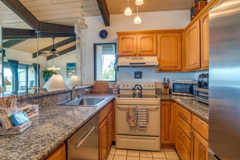NAP-C37 Cook with ease in this open-beam kitchen featuring granite counters, oak cabinets, and views that stretch to the sea