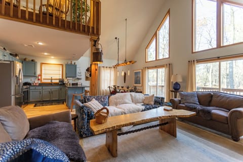 Airy living room with vaulted ceilings and cozy charm.
