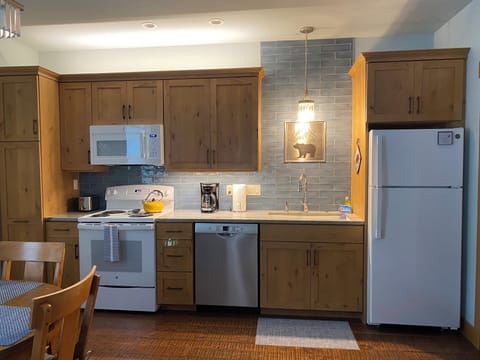 Full kitchen with dishwasher, microwave.