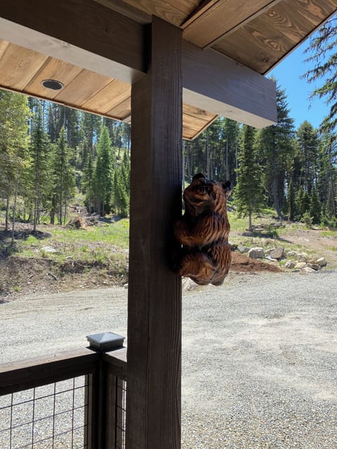 Porch wood-carved bear greets your arrival.