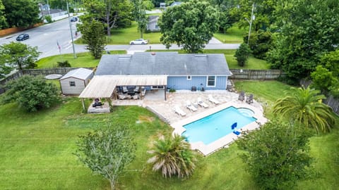 Spread out and unwind in this fully fenced half-acre yard — poolside lounging, shaded seating, and a perfect setup for outdoor entertainment.