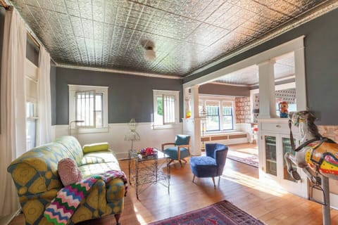 Down sofa, tin ceiling, restored casement windows and birds eye maple floors.